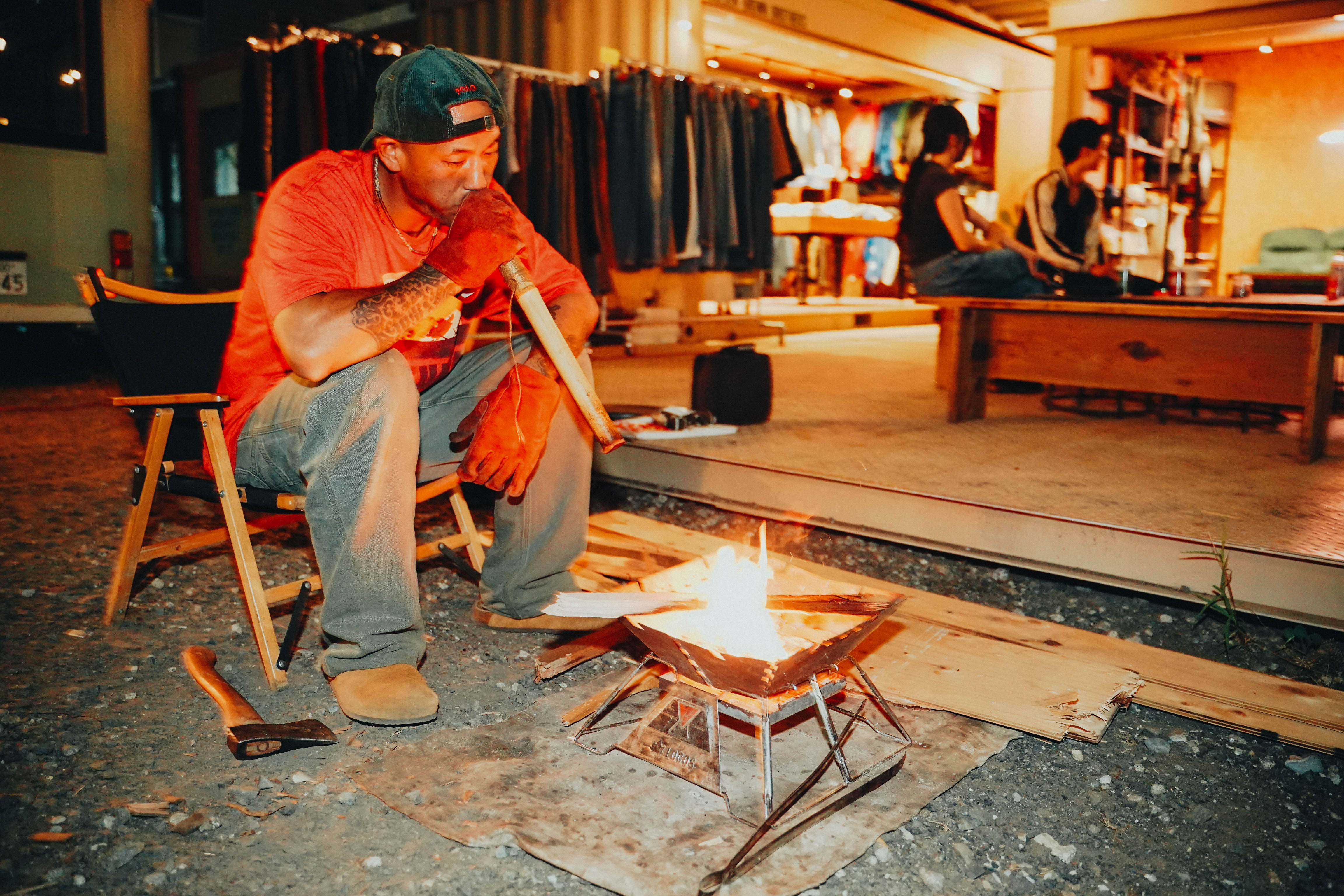 Man sitting beside a bonfire